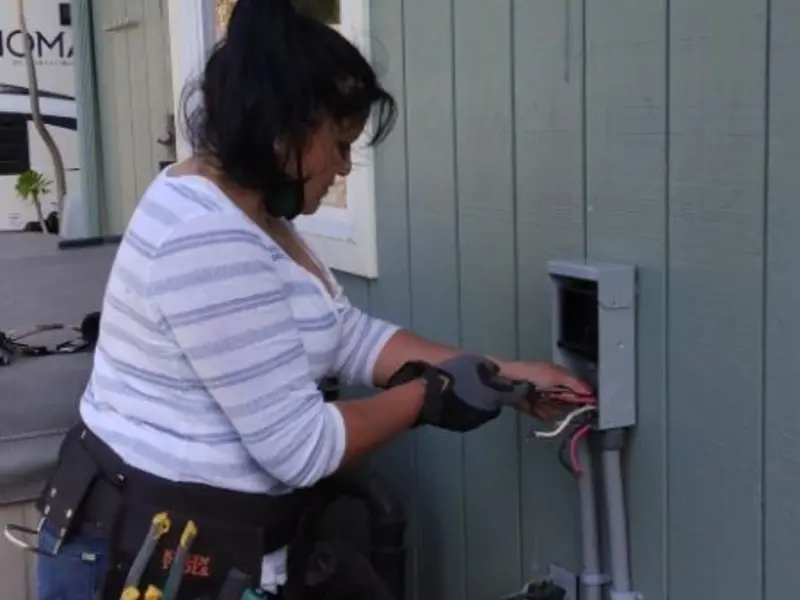 Licensed electrician wiring an exterior subpanel in Brodhead